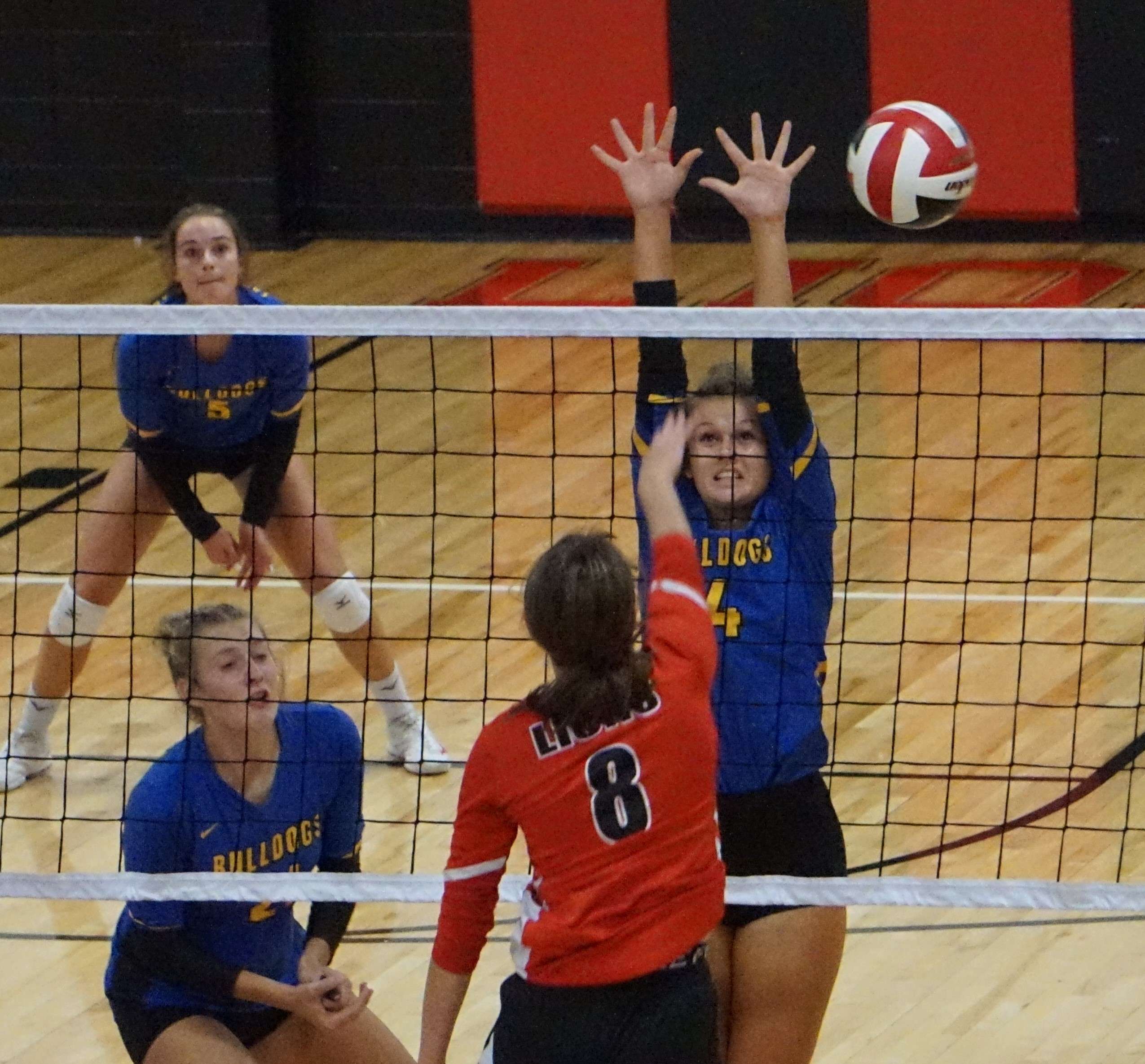 St. Joseph Christian's Ella DuBois (8) tries to hit a ball past East Buchanan's Sidnee Carr (4) during Monday's match. Photo by Tommy Rezac.