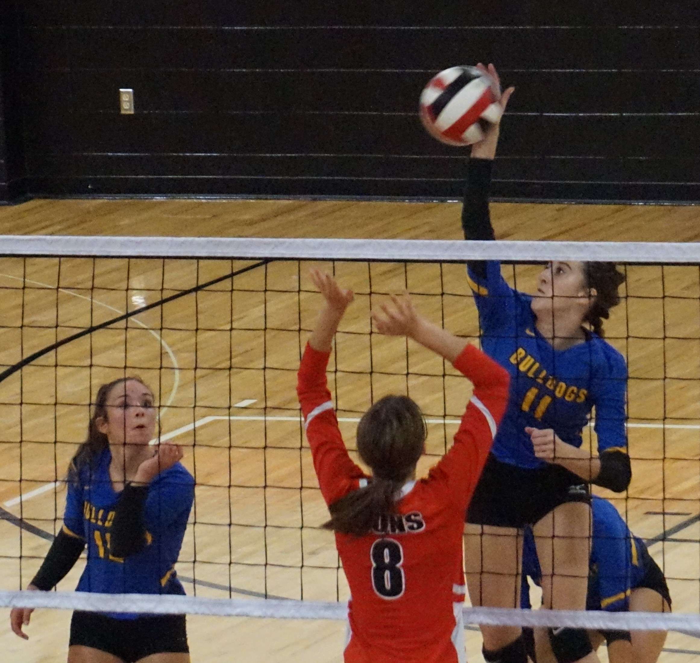 Holly Caylor (11) tries to hit a ball past St. Joseph Christian's Ella DuBois (8).