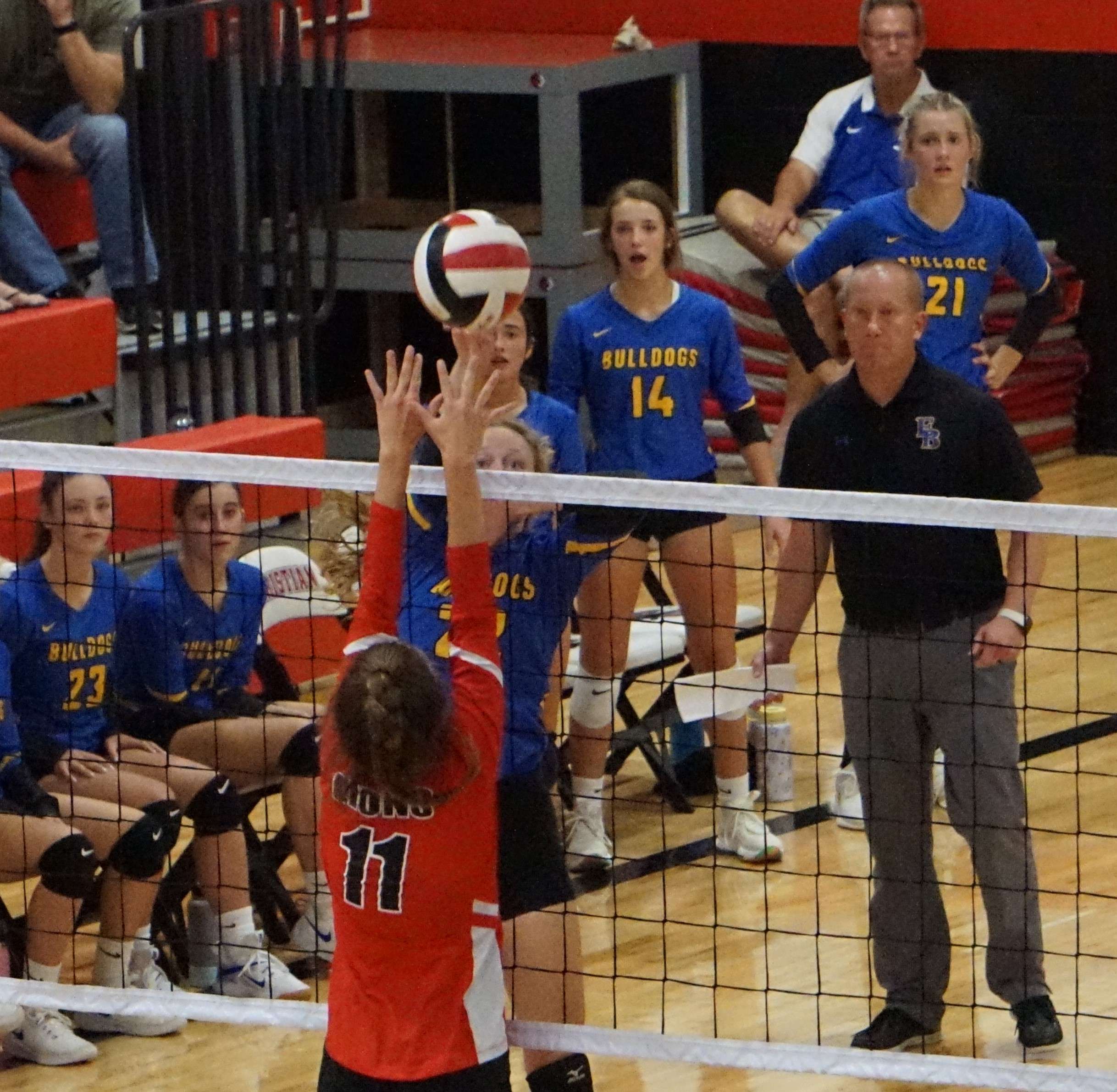 Rilyn Sherwood tries to hit a ball over the block over St. Joseph Christian's Chloe Burnham.