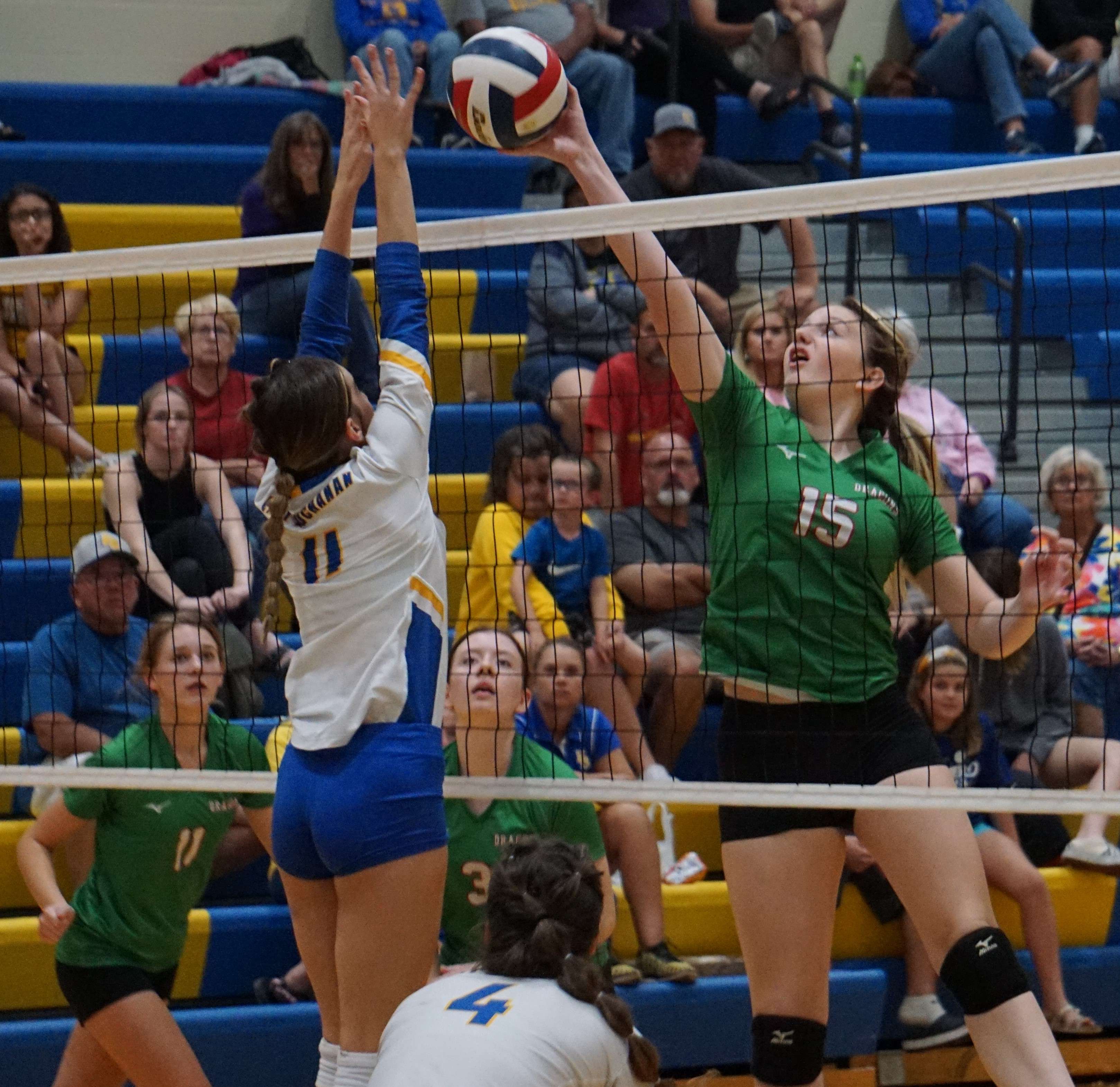 East Buchanan's Holly Caylor (11) tries to block Mid-Buchanan's Mallie Lieffring. Photo by Tommy Rezac.