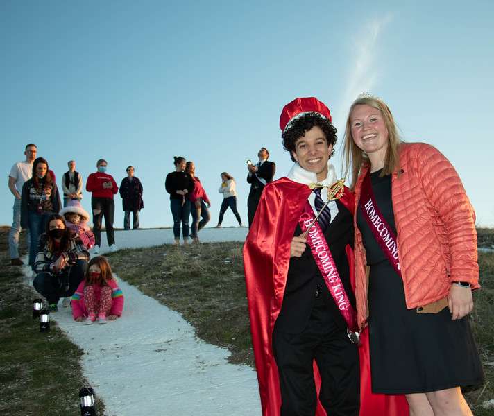 Chadron State College Homecoming King Damien Zuniga of Colorado Springs, Colo., left, and Queen Emily Hansen of Hemingford, Neb., right, pose during the lighting of C Hill April 21, 2021. (Tena L. Cook/Chadron State College)