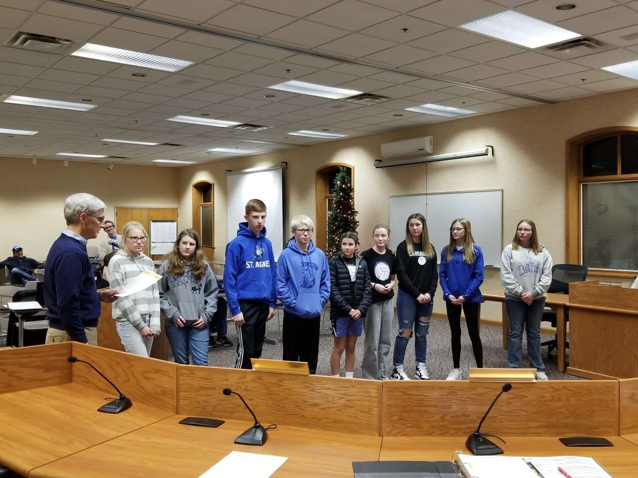 Councilman John McGhehey presents the Catholic Schools Week proclamation to St. Agnes Academy students. 