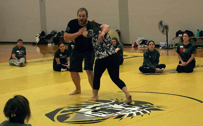 Stefan and Amy Gildemeister of Blue Guardian self -defense demonstrate a self-defense move during a self-defense class for women on Saturday at FHSU.<br>