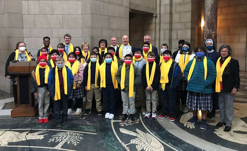 Gov. Ricketts (holding proclamation) with State Senators, school choice advocates,and students/faculty from St. James Elementary School in Crete.