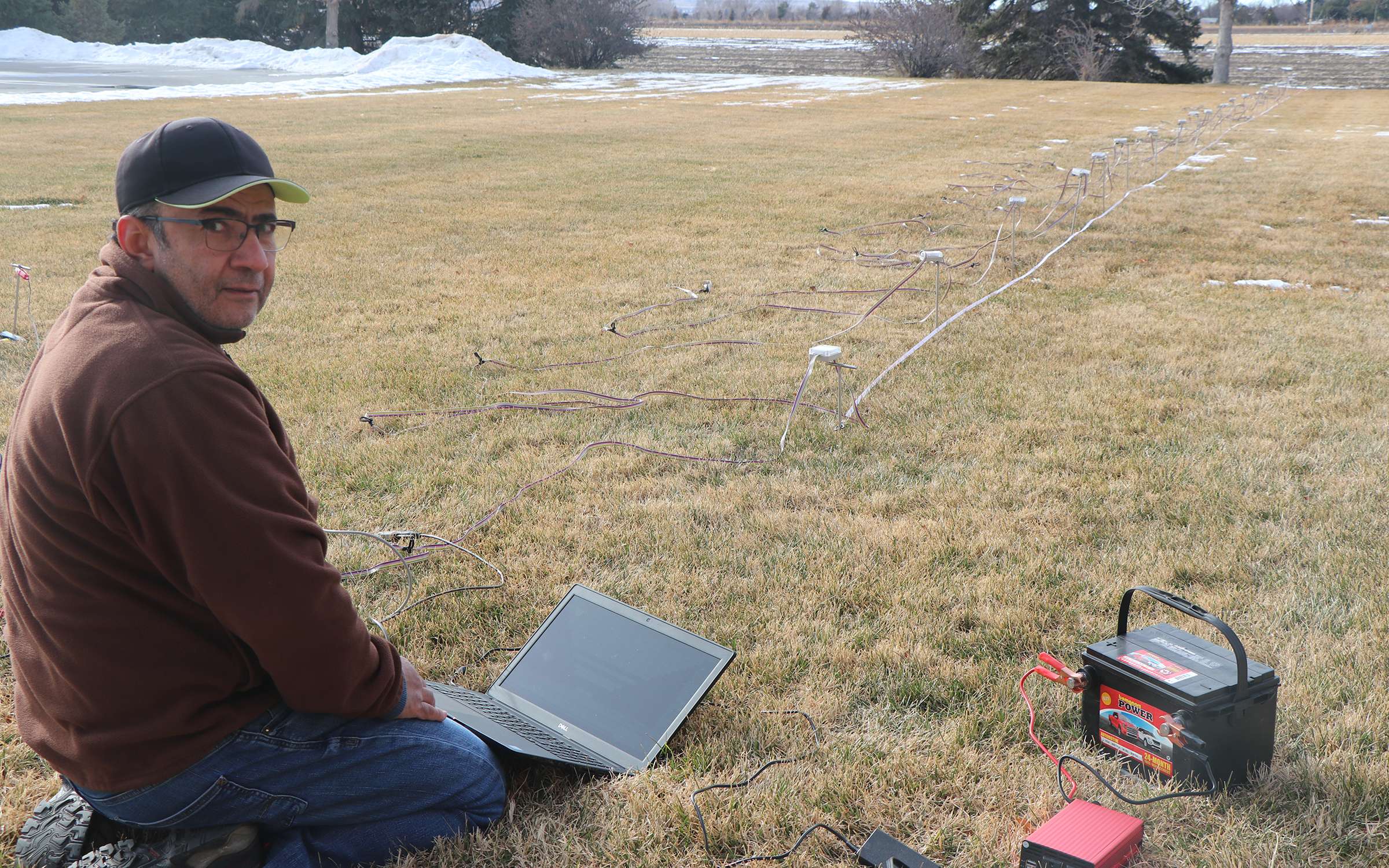 Mohamed Khalil during the resistivity survey, with a laptop computer and battery for the power source.