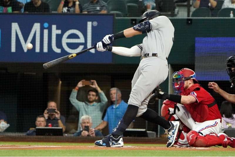 <b>New York Yankees' Aaron Judge hits a solo home run, his 62nd of the season, during the first inning in the second baseball game of a doubleheader against the Texas Rangers in Arlington, Texas, Tuesday. With the home run, Judge set the AL record for home runs in a season, passing Roger Maris.</b> (AP Photo/LM Otero)