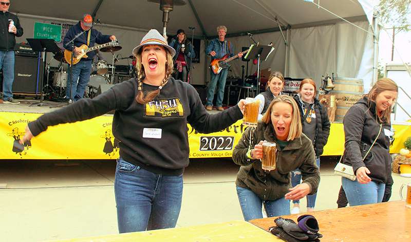 The winner of the women's stein holding contest celebrates during Octoberfest Friday. Photo by Cristina Janney/Hays Post<br>