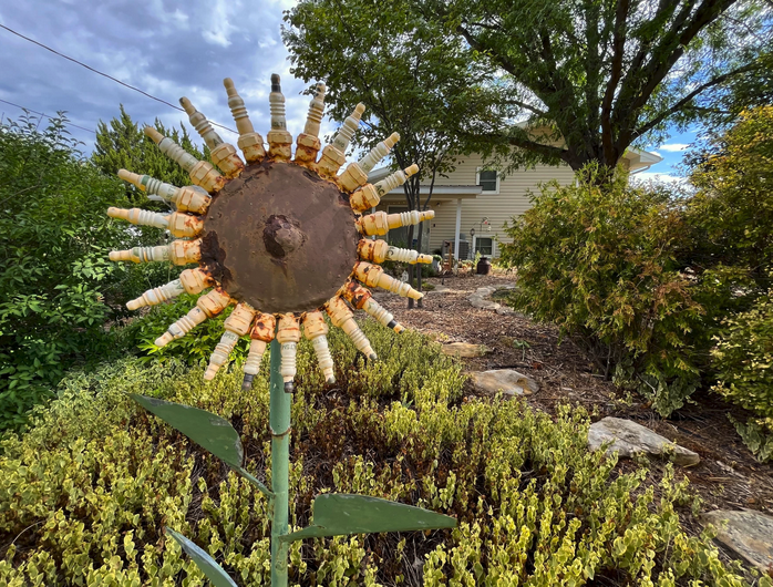 This yard and others like it in Hays have removed grass entirely in favor of xeriscaping with rocks, mulch and drought-tolerant plants. David Condos / Kansas News Service
