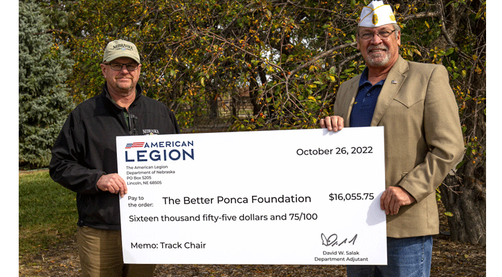 Jeff Fields, Parks Division Administrator at Nebraska Game and Parks, accepts a donation from Dave Salak, state adjutant for the Nebraska American Legion. The American Legion donated $16,055 to the agency for the purchase of an all-terrain wheelchair for state park visitors to use to experience the outdoors.