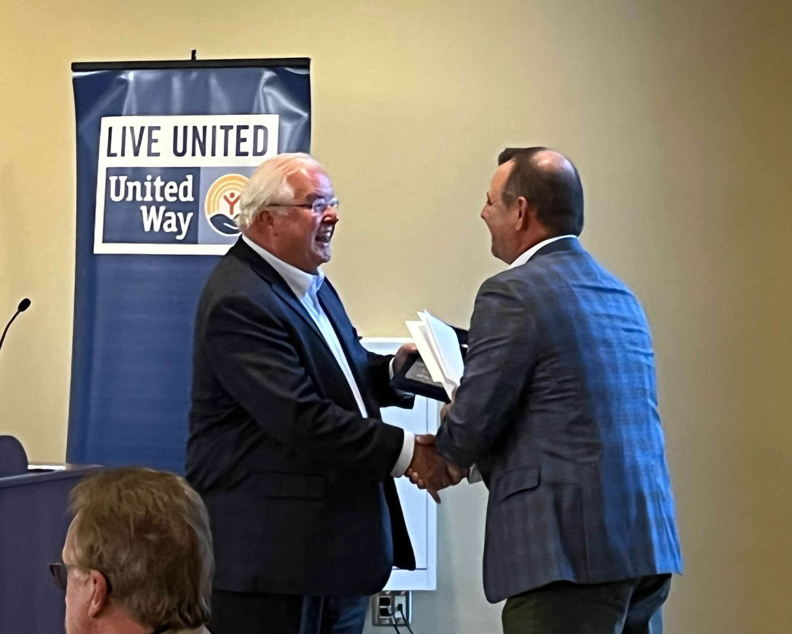 St. Joseph mayor John Josendale (left) presents Scott Albers, the United Way of St. Joseph campaign chair (right) with a key to the city at the Rogers Pharmacy Hall of Fame room inside of Spratt Stadium Thursday. Photo by Tommy Rezac.