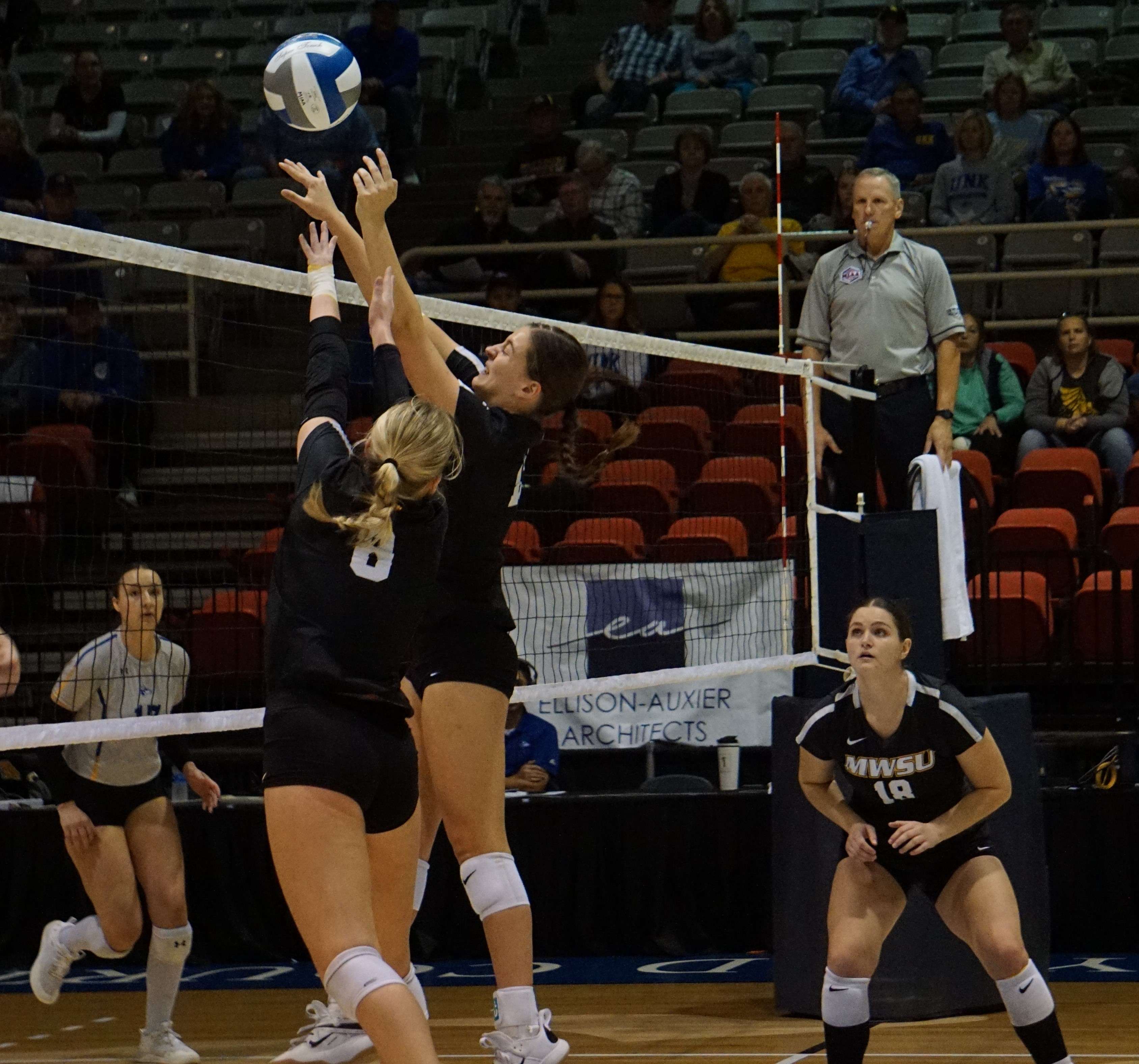 Emma Salker and Hailey Crane try and throw a block.