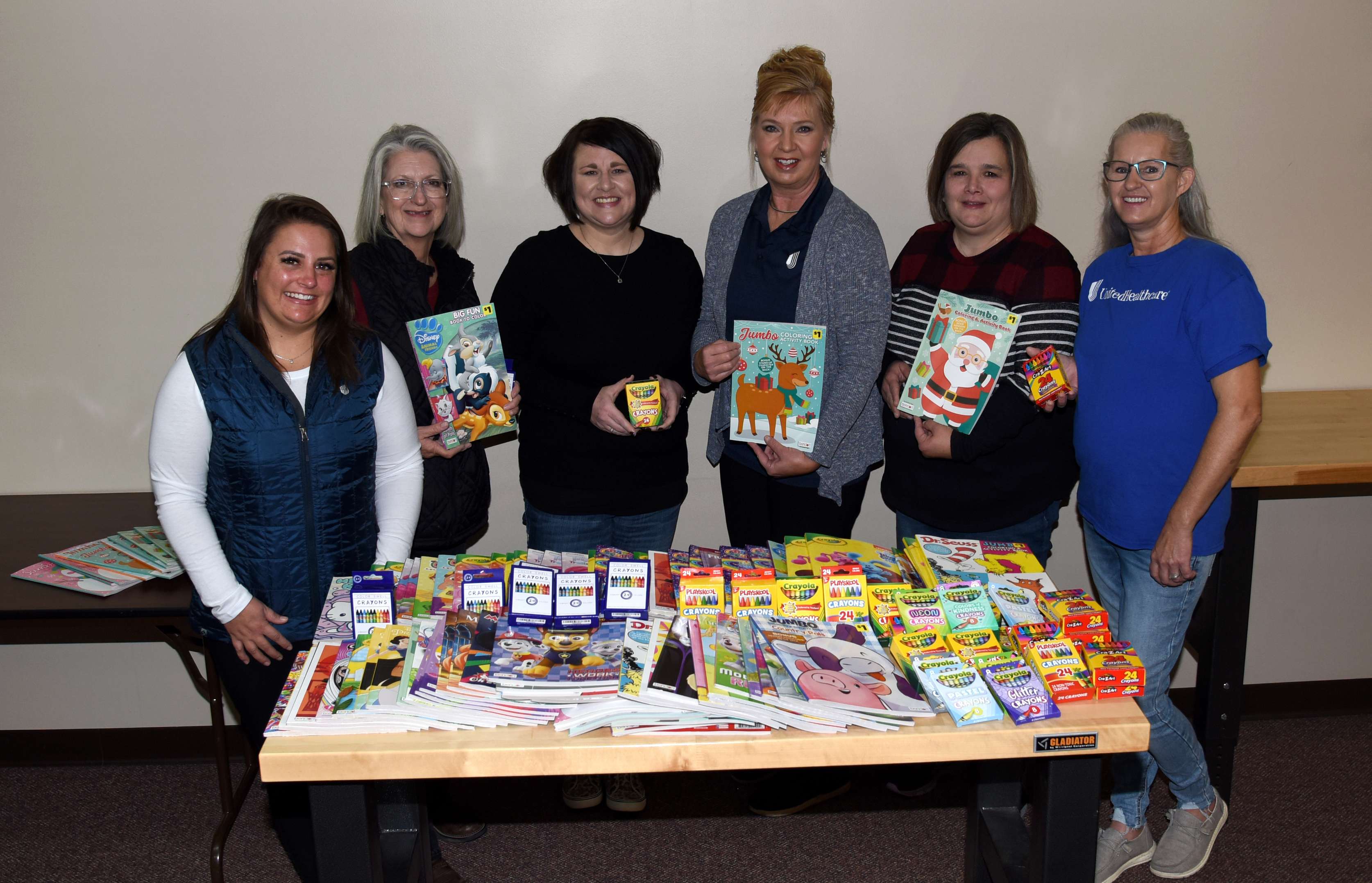 <b>Caring for Community -</b> UnitedHealthcare representatives deliver their coloring books and crayons, donated on Nov. 8, to the Rosewood Miracle Workers AKTION Club. Standing left to right: Katie Leikam (UHC care coordinator); Tonya Burton (RW AKTION Club assistant sponsor); Amanda Rome (UHC care coordinator); Robin Rziha (UHC care coordinator); Frankie Pelster (RW AKTION Club sponsor); and Christine Martinez (UHC care coordinator). 