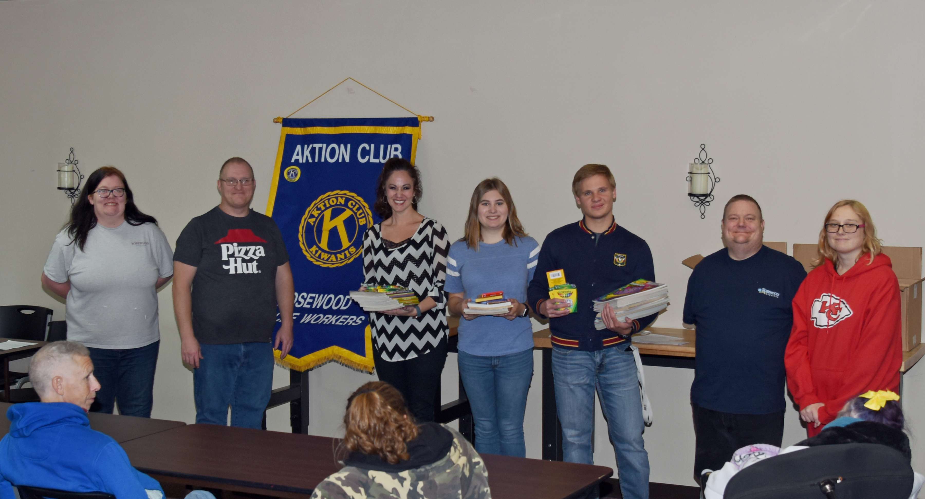 <b>GBHS Honor Society Donation –</b> Members of the Great Bend High School National Honor Society donate coloring books and crayons to Rosewood AKTION Club during the Club’s November meeting on Nov. 11. Standing left to right are officers for Rosewood AKTION Club and GBHS NHS: Destiny Thomas (RW), Josh Trimmer (RW), Kaycie Teghtmeyer (GBHS NHS sponsor); Madelynn Gregg (GBHS NHS); Gavin Hirsh (GBHS NHS); Kurtis Coleman (RW), and Ashley Hullett (RW). 