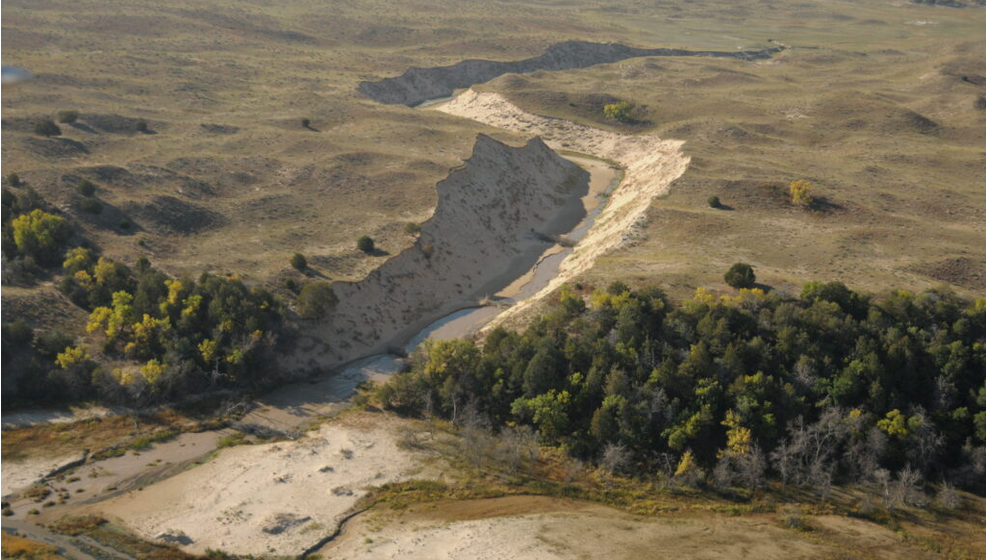 More than a million tons of sand washed into the Snake River after a rancher in 2021 dug a ditch in the fragile Sandhills to drain a flooded pasture. This photo was from October. (Courtesy of John Sidle)