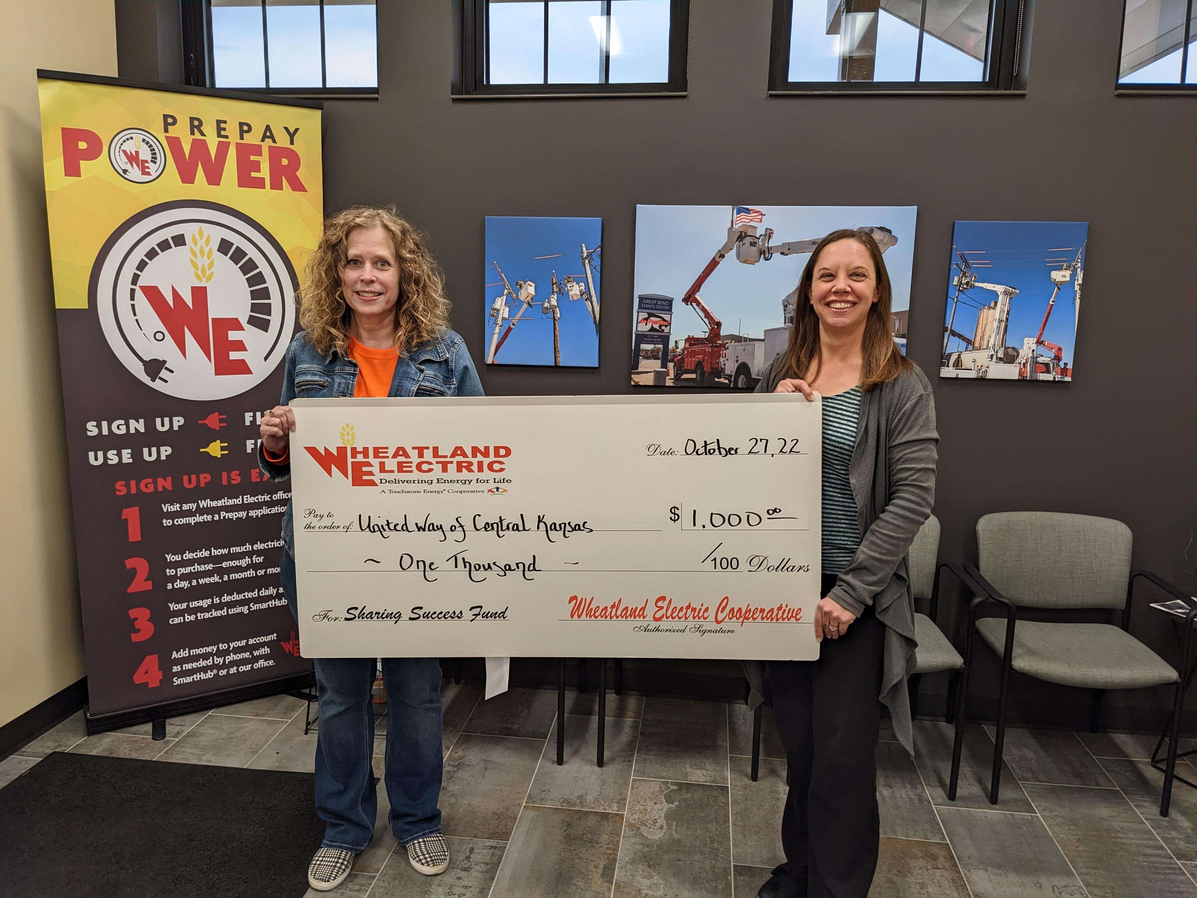 Wheatland Electric member services and key accounts manager Mary Hoisington (left) presents a $1,000 Sharing Success grant to Charell Owings (right), executive director of the United Way of Central Kansas. Grant funds will be used to support the community impact project, Laundry Love.