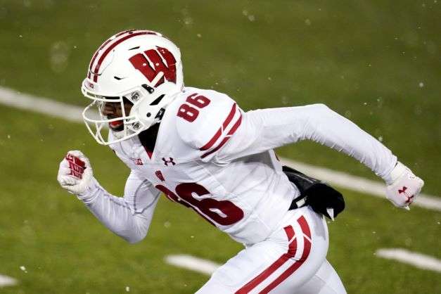 Wisconsin wide receiver Devin Chandler runs up field during an NCAA college football game against Iowa, on Dec. 12, 2020, in Iowa City, Iowa. Chandler, who transferred to the University of Virginia, was one of three Virginia football players killed in a shooting, Sunday, Nov. 13, 2022, in Charlottesville, Va., while returning from a class trip to see a play. (AP Photo/Charlie Neibergall, File)