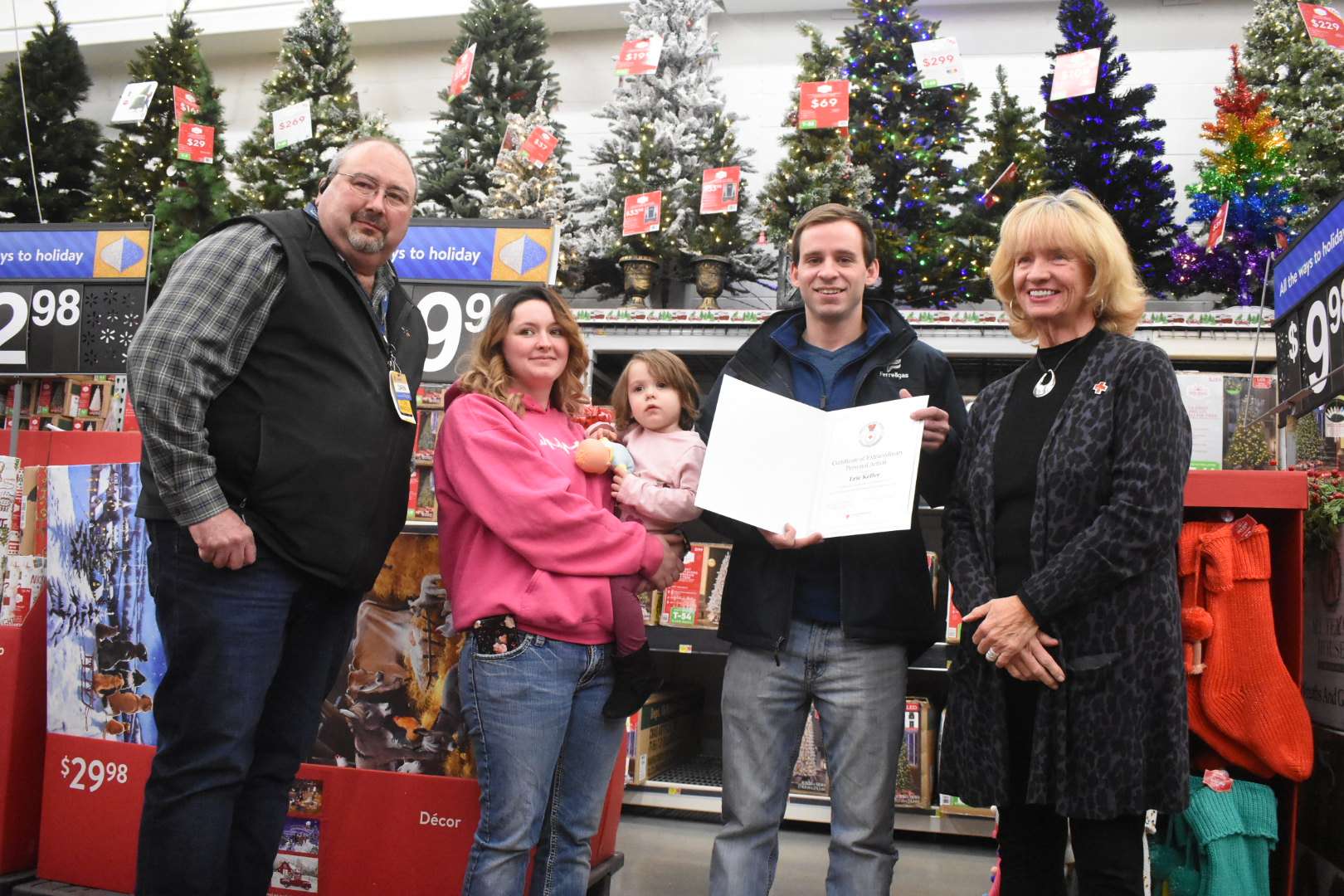 Eric Keller received the American Red Cross Certificate of Extraordinary Personal Action in a ceremony Thursday night. Keller was joined by, from left: Great Bend Walmart Store Manager Darin Dreiling, Lacy Rodriguez, Nova, and Red Cross Executive Director Jane Blocher.