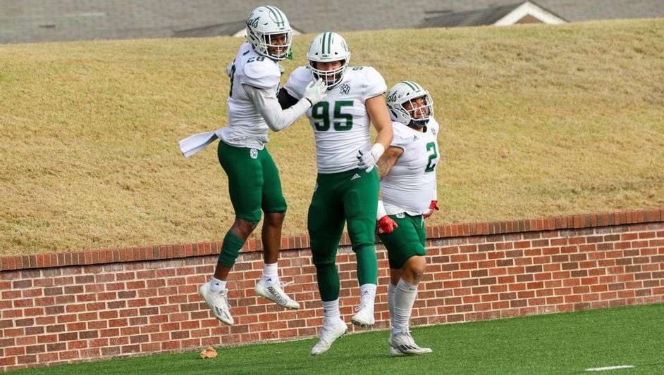 Northwest's Elijah Green, Trevon Peak, and Jake Fisher celebrate a big win over previously undefeated Ouachita Baptist/ Photo by Ryan Milke, Northwest Athletics