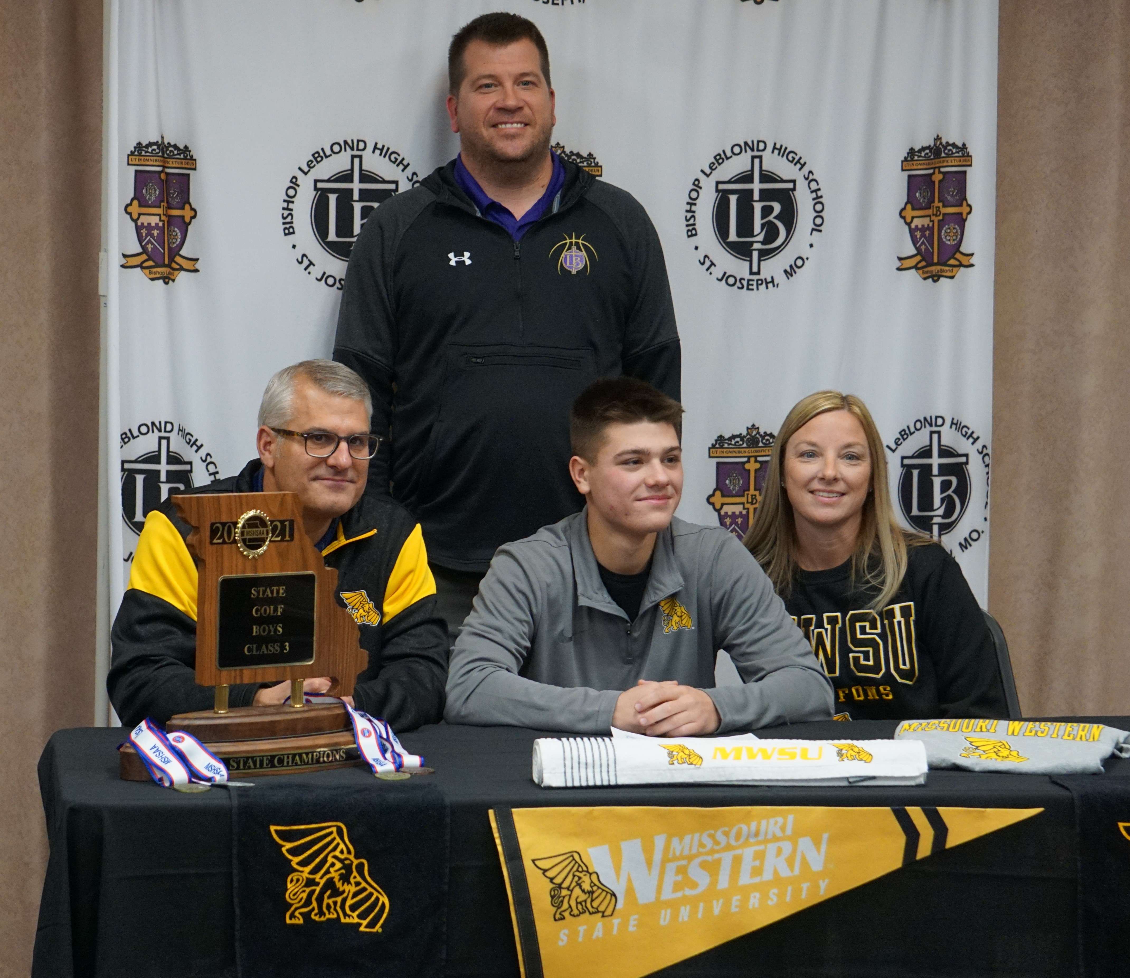 LeBlond coach Mitch Girres (center) joins the Schoeberls for a photo after Tuesday's signing.