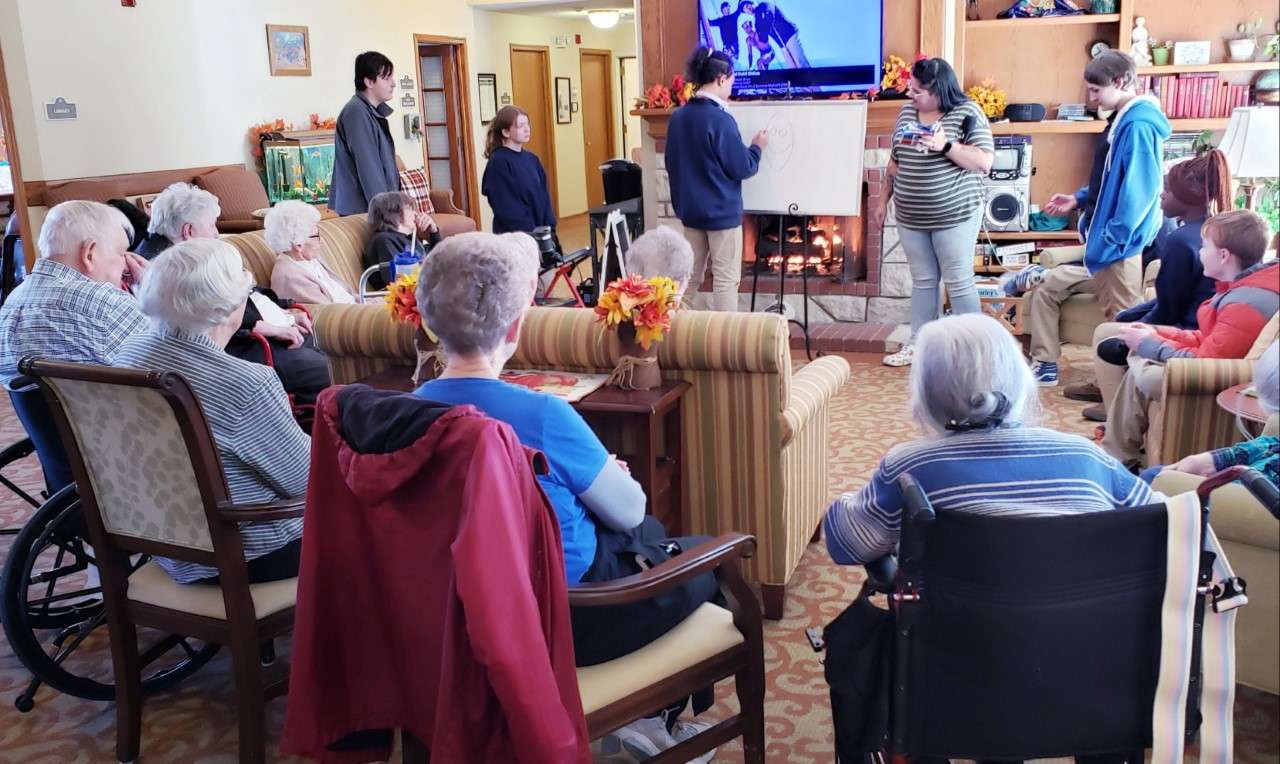 Students visit with seniors at Brookdale Junction City