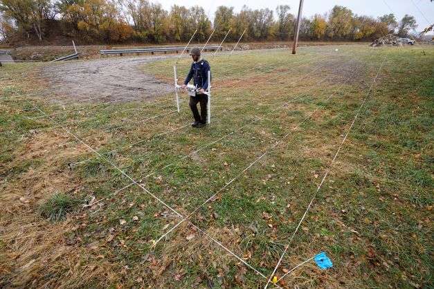 A member of a team affiliated with the National Park Service uses ground-penetrating radar in hopes of detecting what is beneath the soil while searching for over 80 Native American children buried at the former Genoa Indian Industrial School, Thursday, Oct. 27, 2022, in Genoa, Neb. For decades the location of the student cemetery has been a mystery, lost over time after the school closed in 1931 and memories faded of the once-busy campus that sprawled over 640 acres in the tiny community of Genoa. (AP Photo/Charlie Neibergall)