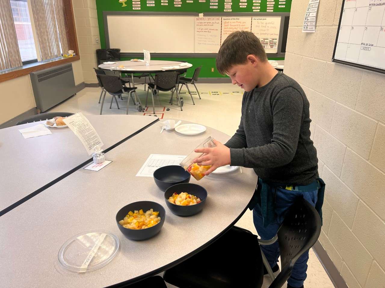 A Westside third grader helps prep fruit for the school's family-style lunch. Courtesy&nbsp; photo<br>