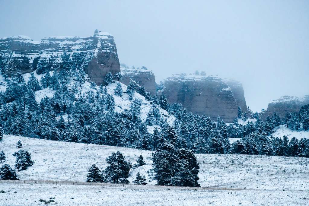 Snow and fog hang above the Red Cloud Buttes at Fort Robinson State Park in Dawes and Sioux counties. Justin Haag, Nebraskaland Magazine, Nebraska Game and Parks Commission