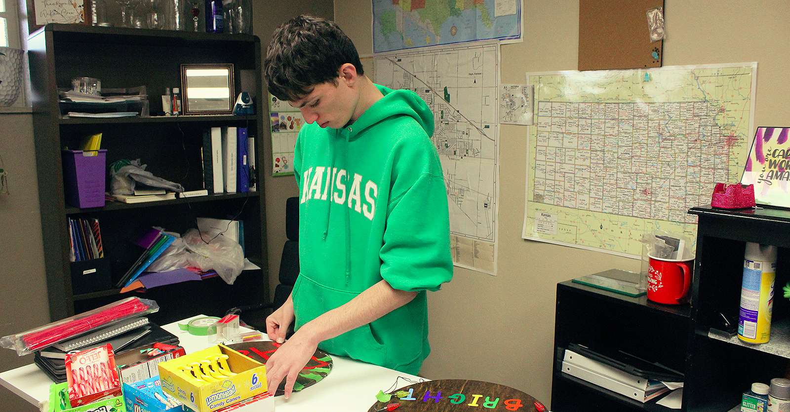 Johnny Fizthum, 19, WeKan Center student, makes a sign for the <a href="https://www.facebook.com/bethesdaplaceinc">Bethesda Place</a> holiday sale in downtown Hays this weekend. Photo by Cristina Janney/Hays Post<br>