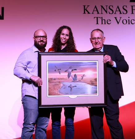 Kansas Farm Bureau Natural Resources Award winners Jay and Jessica Young with KFB President Rich Felts.