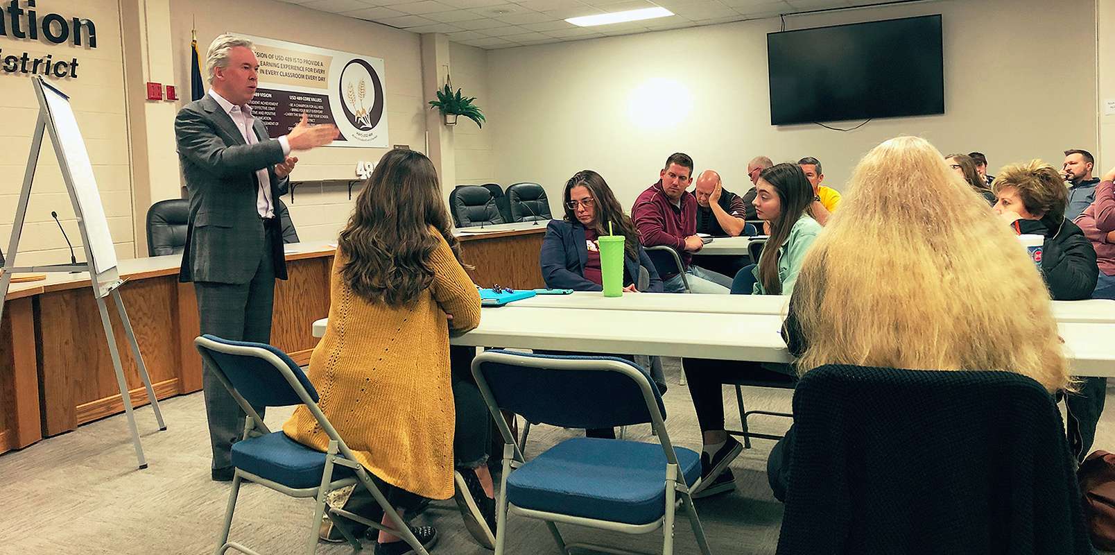 John Jenson, Jostens consultant, talks to the Hays USD 489 rebranding committee members about Hays High School's logos and mascot Monday night. Photo by Cristina Janney/Hays Post