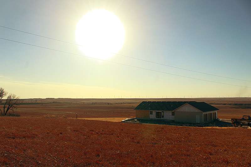 Logan Glaze's family is still working to rebuild their home near the intersection of U.S. 183 and Homestead a year after the Four County Fire burned the home and 2,000 acres of the surrounding grassland. Photo by Cristina Janney/Hays Post <br>