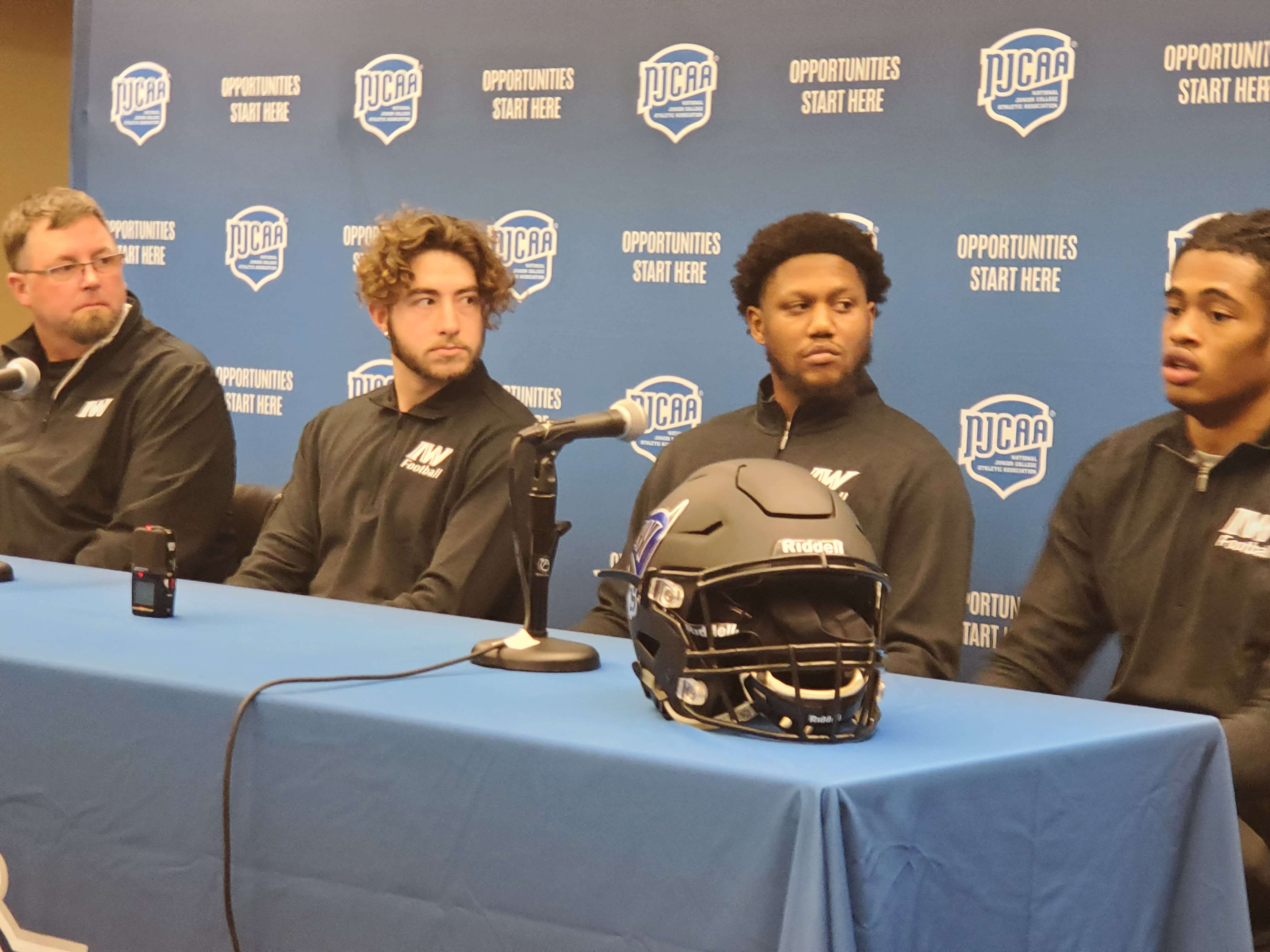 From left: Iowa Western head coach Scott Strohmeier, tight end C.J. Horton, quarterback James Graham and defensive back Will Lee answer questions at Tuesday's press conference.&nbsp;