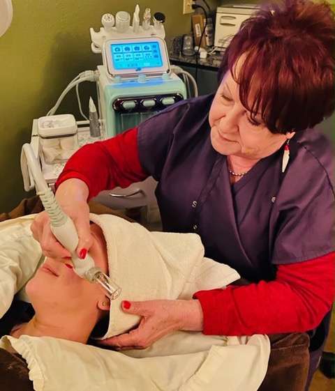 Allene Owen provides a facial treatment to a client at Renue Salon, Spa & Fashion Boutique. Renue recently started using its new facial equipment.