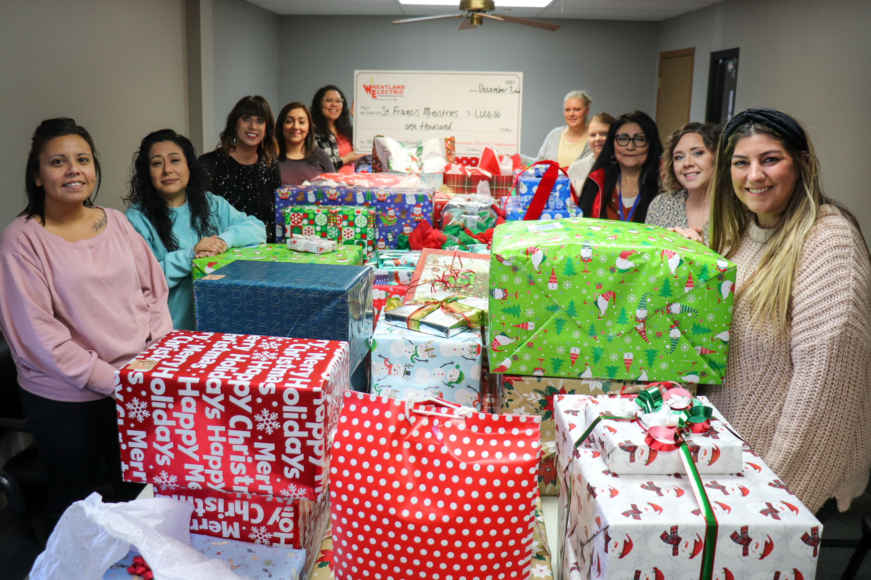 Wheatland Electric employees and trustees sponsored 105 children through Saint Francis Ministries’ Christmas for Kids program this year. Alli Conine, director of member services and corporate communications (third from left) poses with representatives of Saint Francis in their Garden City office in front of this year’s presents. 