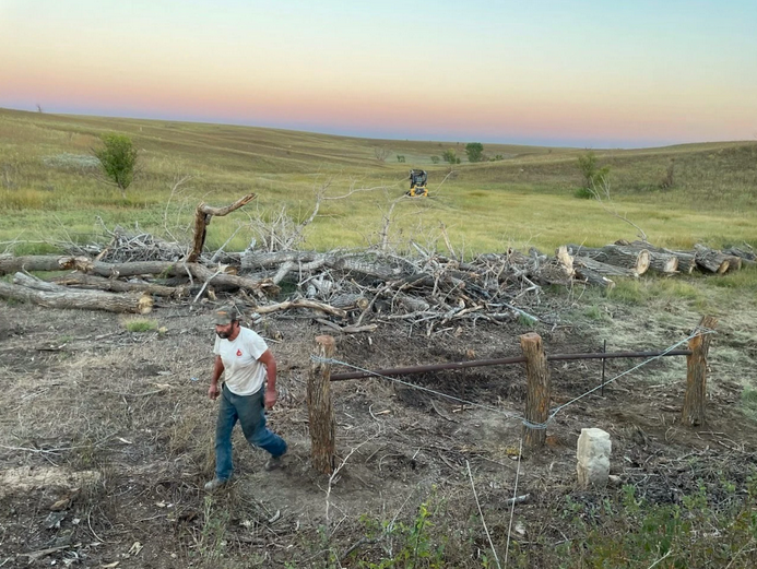 Rancher Rich Koester installs part of his new fence earlier this year. In Russell County, the fire destroyed more than 500 miles of fencing. Courtesy of the Koester family