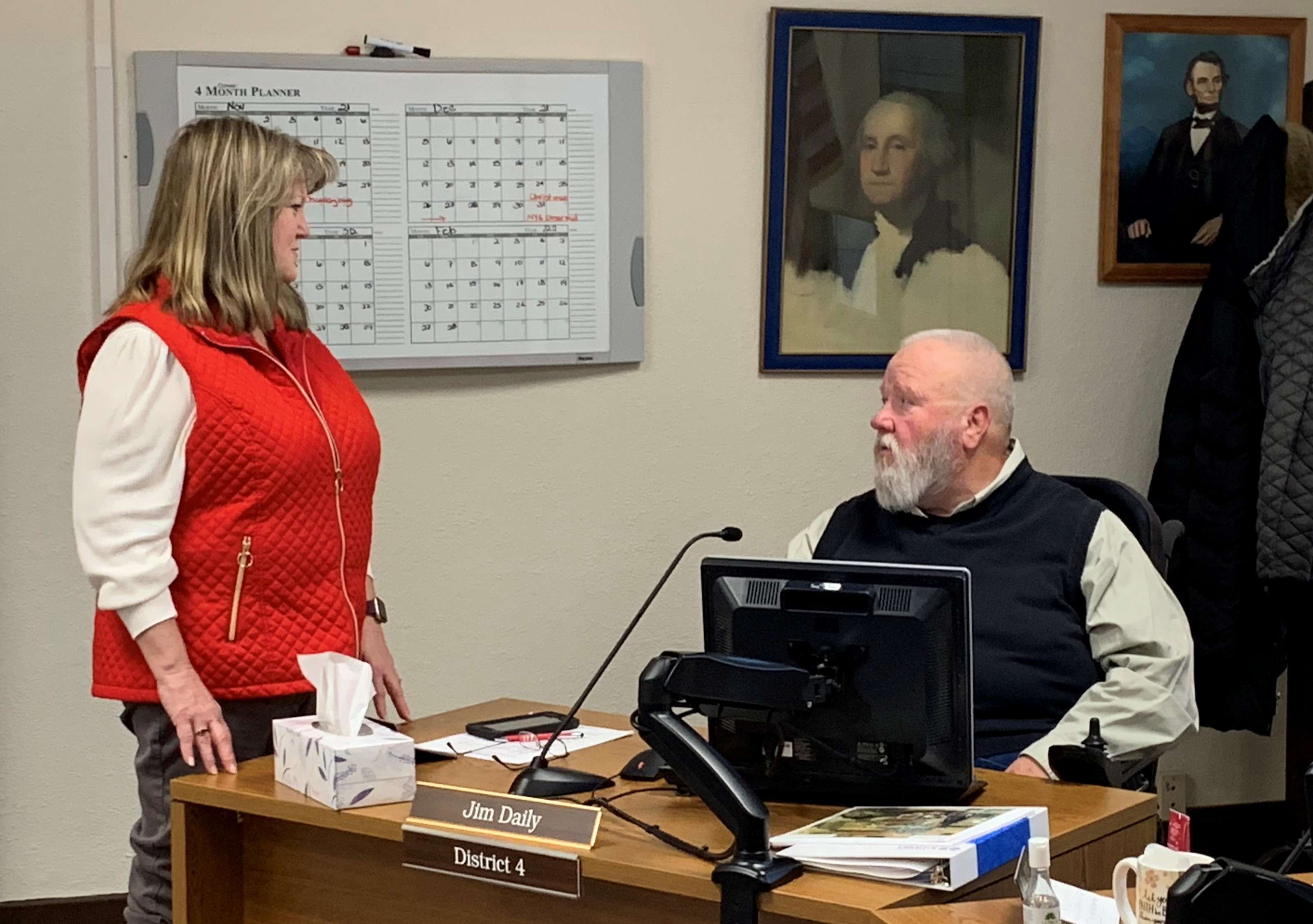 Barb Esfeld speaks with Jim Daily after Wednesday's commission meeting