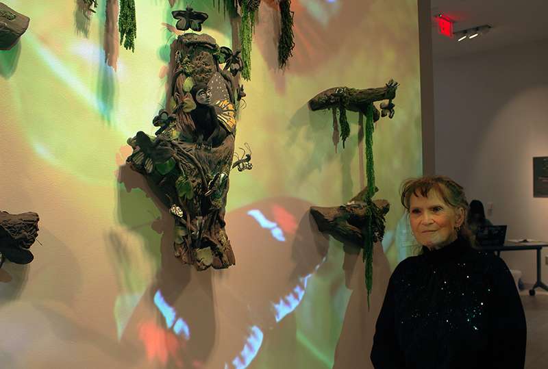 Artist Kathy Robb with her multi-media art piece "Becoming a Butterfly."<br>