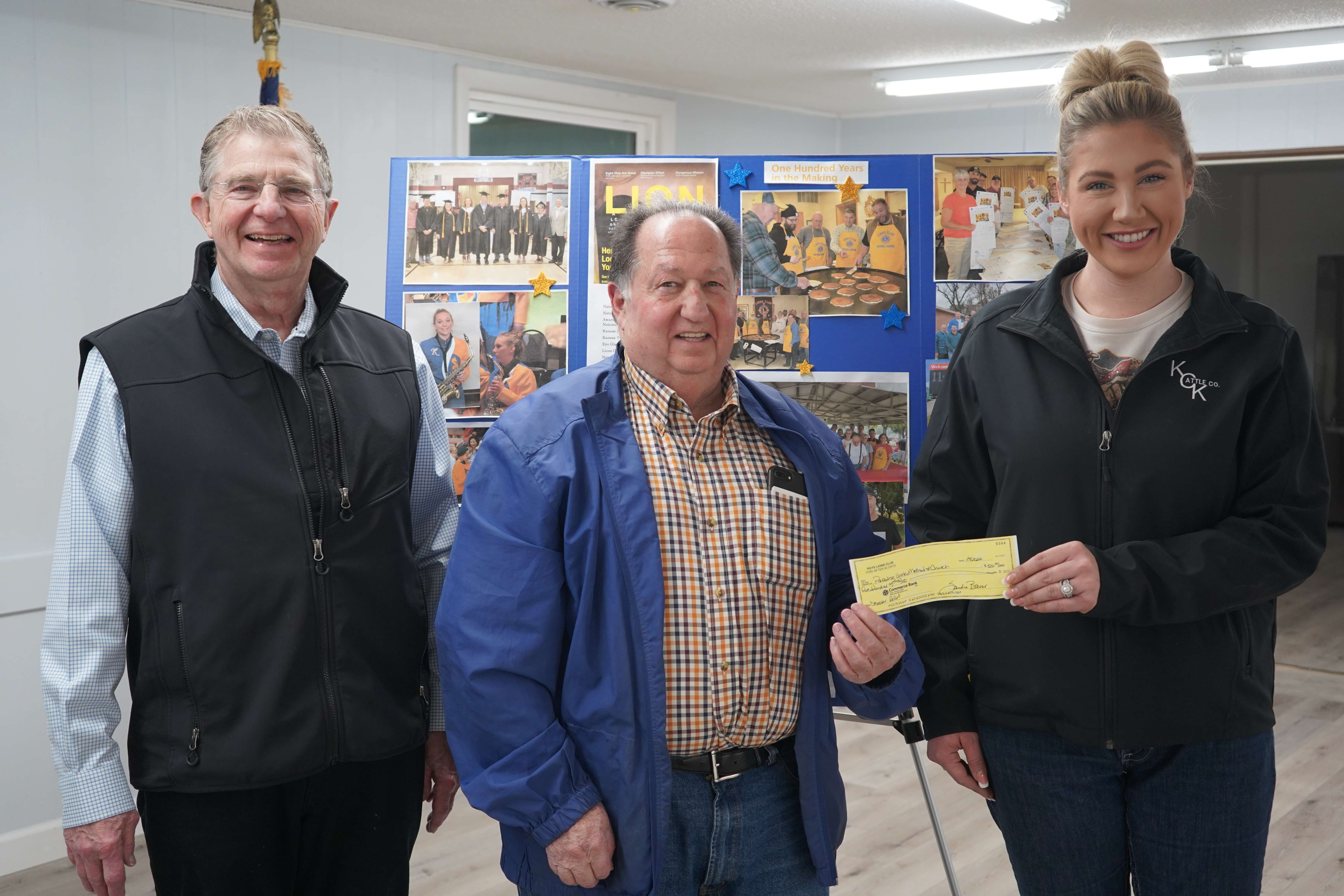 Courtesy photoNatoma Lions Club president Terry Tucker (left) welcomed Jim Huenergarde (center), Lions District Zone K Chair and Kansas Lions Sight Foundation, for presenting the Hays Lions Club’s $500 donation to Kasey Ulrich, Four Country Fire Mitigation Team. 