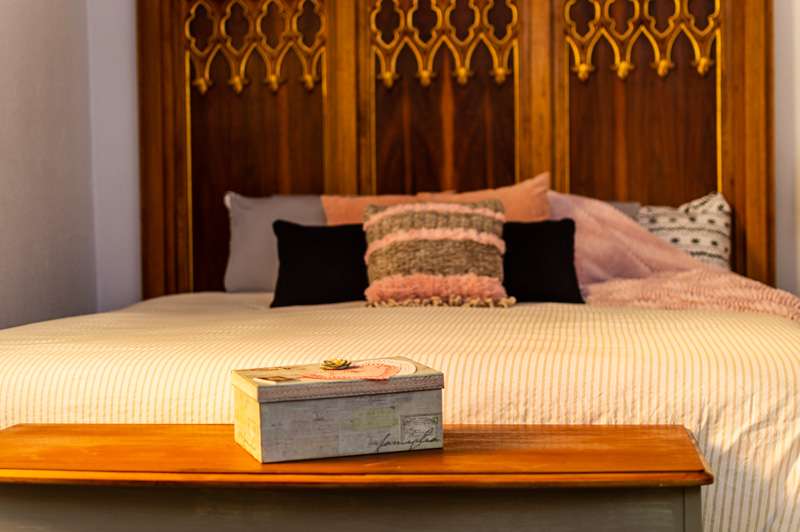 A piece from the altar was used to create a one-of-a-kind headboard in the master bedroom.