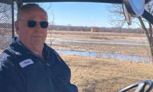 Terry Newland wonders if the proposed big lake will mean he will lose his home along the Platte River. In the background is a well operated by the Lincoln Water System, in the middle of the river. (Paul Hammel/Nebraska Examiner)