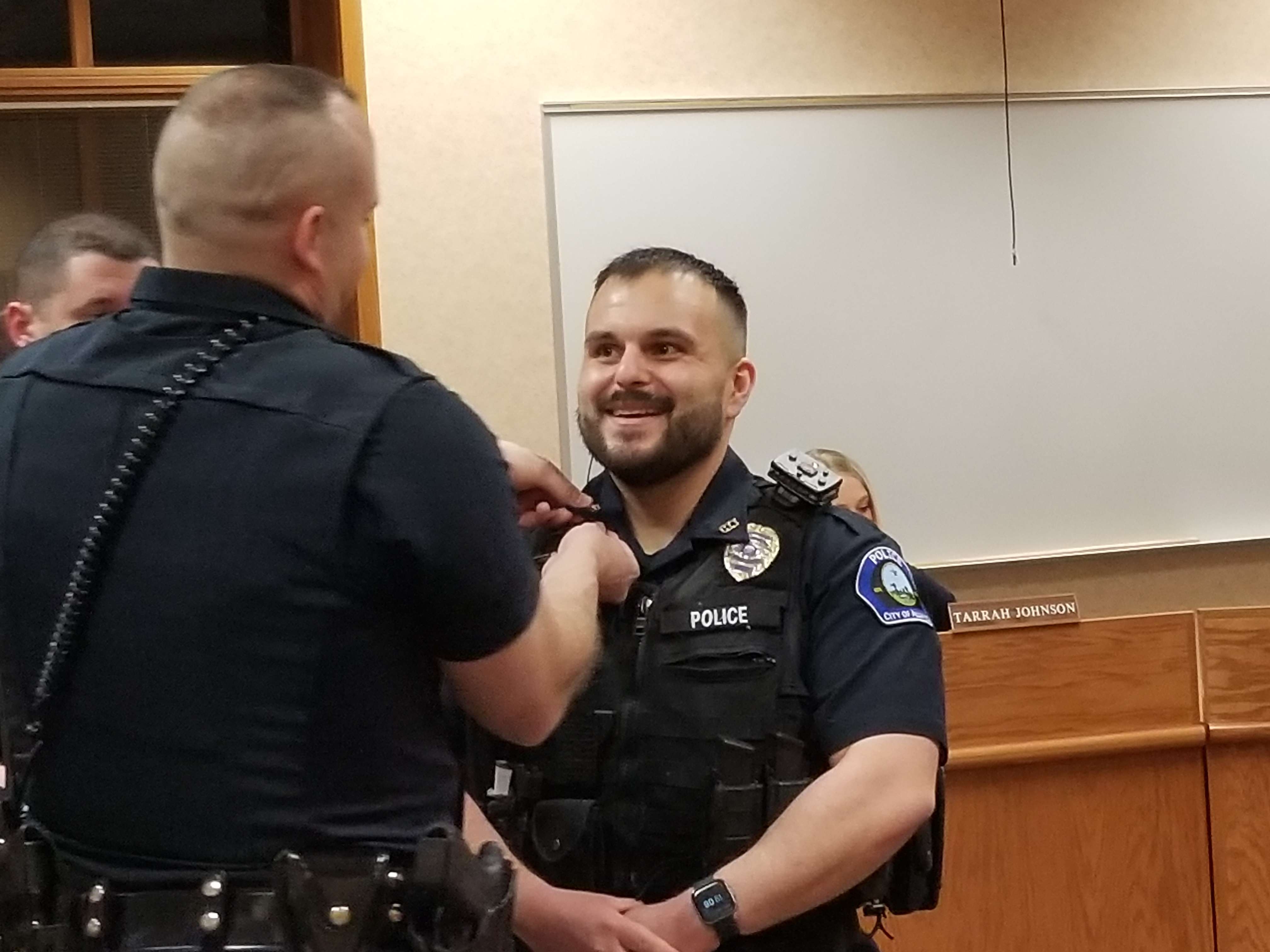 A Nebraska State Patrol trooper pins police badge on&nbsp;Sergeant Yocum.&nbsp;