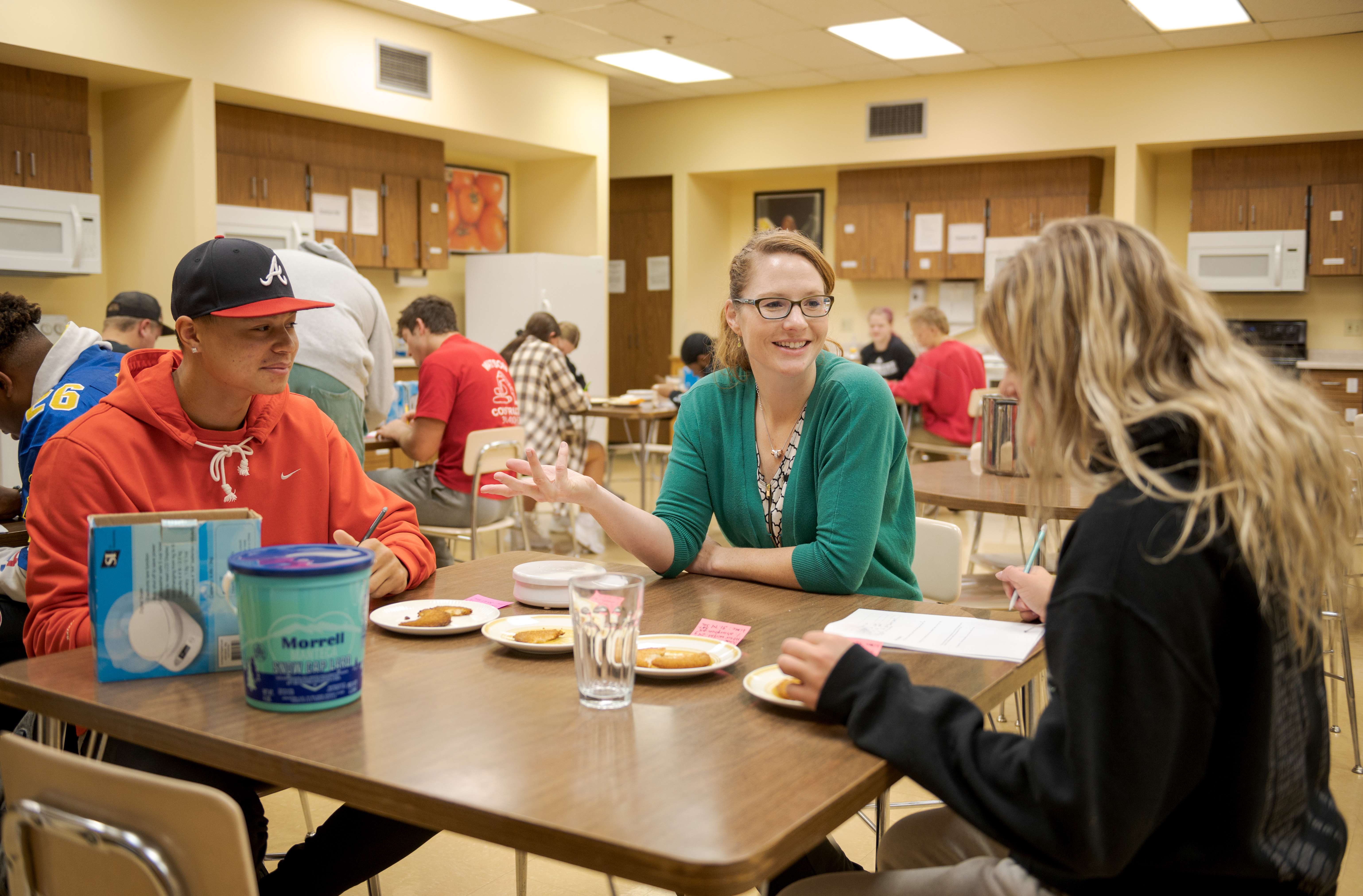 Dr. Erin Norman, center, discusses food and nutrition with Chadron State College students. (Photo by Daniel Binkard/Chadron State College)