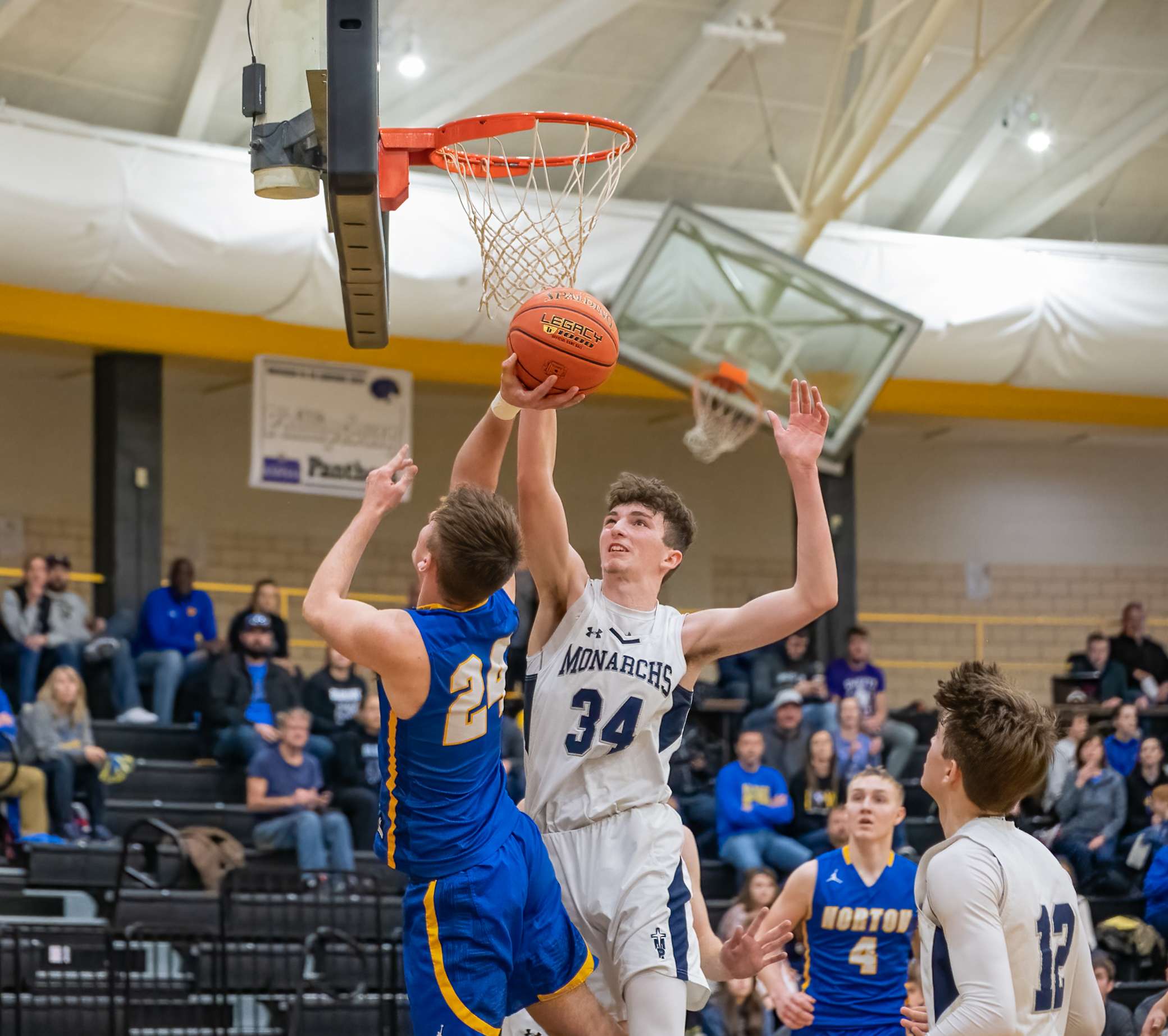 TMP's Dylan Werth challenges Norton's Drake Harding's shot.&nbsp;(Courtesy Bluejay Athletics)