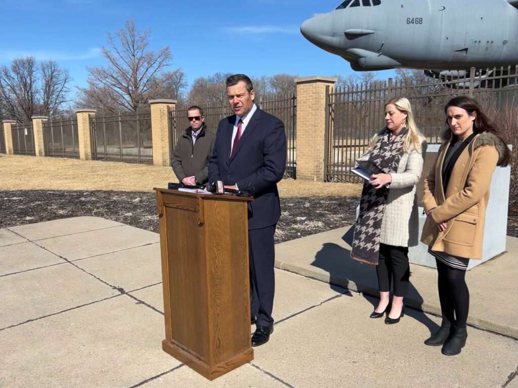 Kansas lawyer Kris Kobach announces a lawsuit involving Air Force members outside the gate at Offutt Air Force Base in Bellevue. (Aaron Sanderford/Nebraska Examiner)