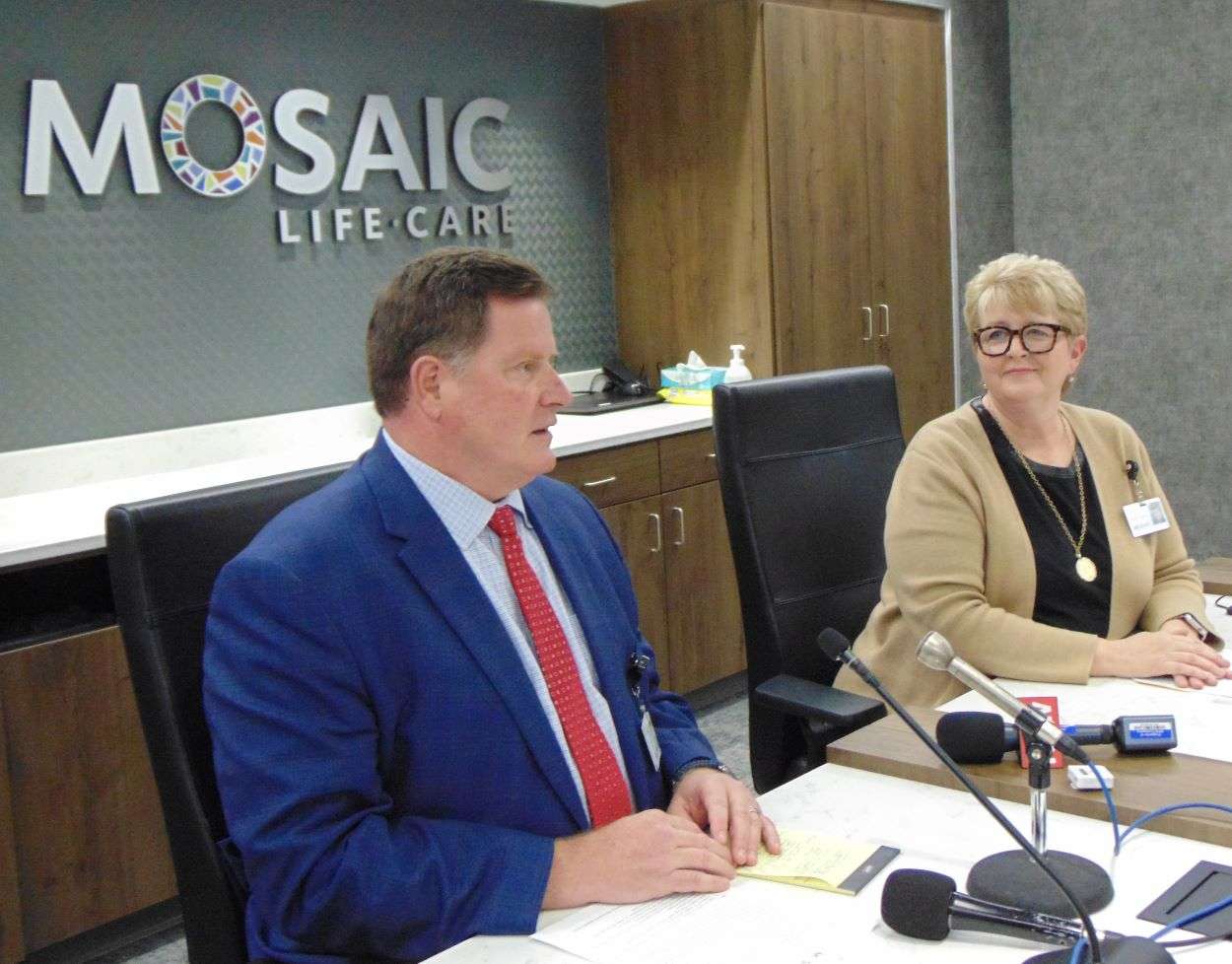 Mosaic Life Care Interim CEO Mike Poore speaks to news media while Mosaic Board Chair Serena Naylor looks on/ Photo by Brent Martin