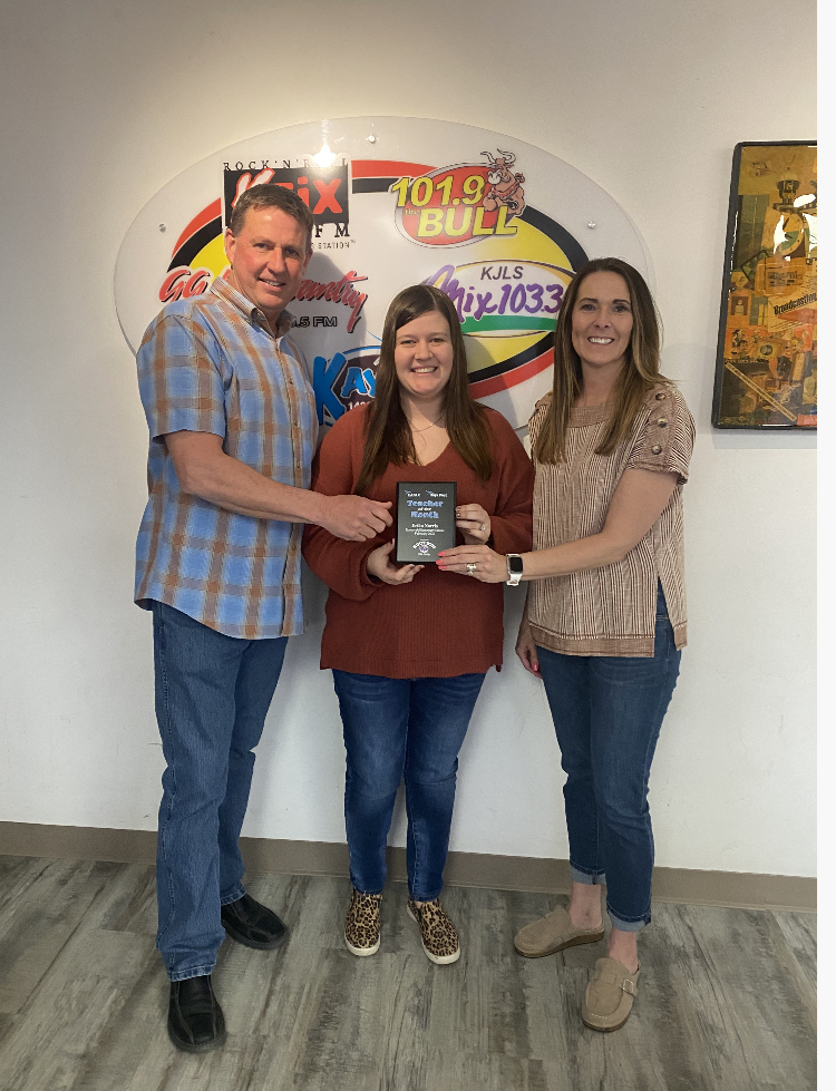 Mark and Lynette Ottley of Nations Auction Elite Realty present Erika Norris, fifth-grade teacher at Roosevelt Elementary School, with the February Hays Post Teacher of the Month Award.