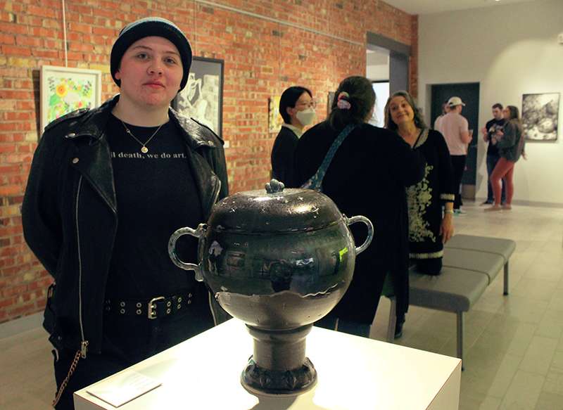 Rylie Hazelton, senior in ceramics from Meriden, with her urn, which is titled "Resting Place." Photo by Cristina Janney/Hays Post