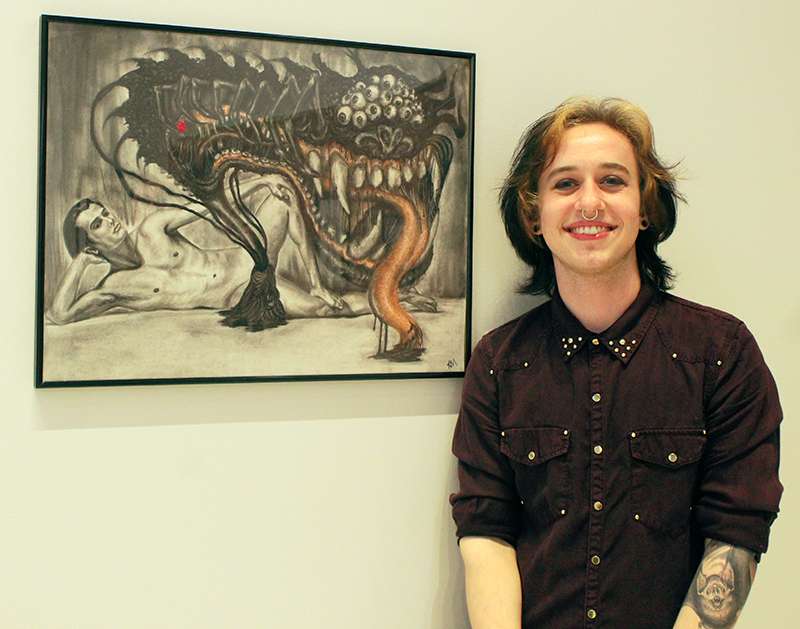 Kiernan McCarty, junior in drawing from Erie, Colo., with his figure drawing titled "Nightmare Before Sex." Photo by Cristina Janney/Hays Post