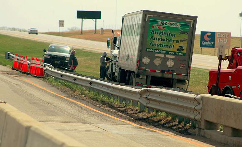 Wreckers work to remove a semi-truck that crashed into a guardrail Wednesday morning on Interstate 70. Photo by Cristina Janney/Hays Post<br>