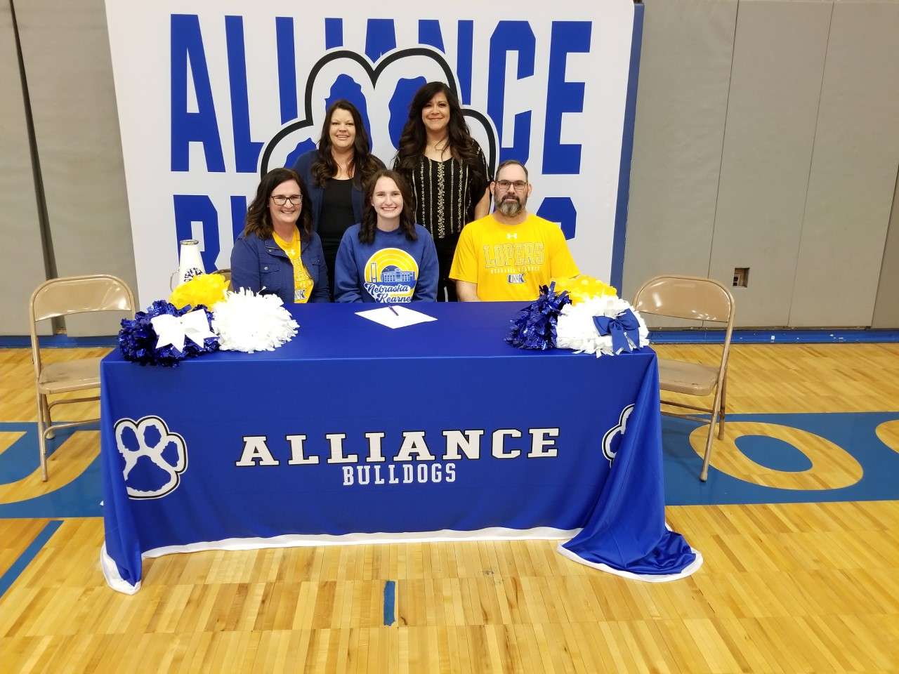 Seated L-R: Shannon Lawrence, Riley Lawrence, Heath Lawrence. Standing: AHS Cheer Coaches/Sponsors Tara Quick, Danielle Swanson